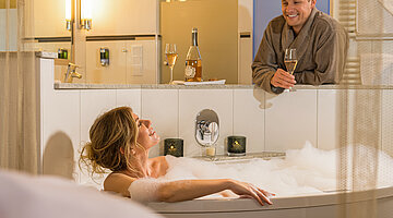 Woman in a hot tub in the Emotion double room at the Hotel Winzer