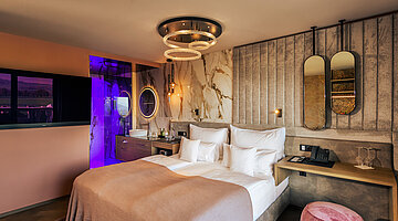 A cosy bed in the stylish Spa double room at Hotel Winzer
