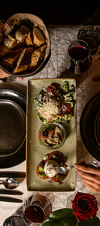 A couple enjoy a meal at the food-sharing table at the Hotel Winzer