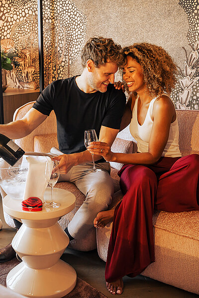A couple enjoying chilled sparkling wine at the Kuschelhotel Winzer in Austria