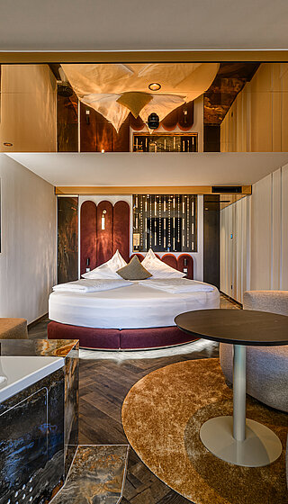 Kuscheltraum Junior Suite with Bathtub Kuscheltraum Junior Suite at Hotel Winzer with double bed, bathtub, cosy living area and contemporary interiors for two