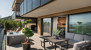 Terrace with a private hot tub at the Private Spa Villa in the Hotel Winzer