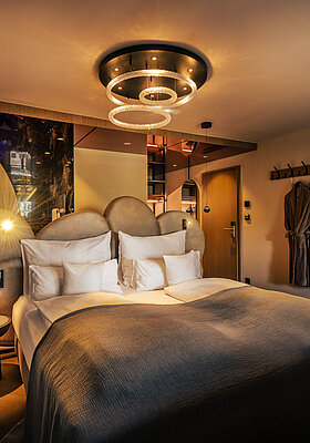 A cosy bed in a Spa Deluxe double room at the Hotel Winzer