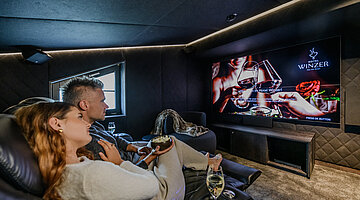 Private Cinema for Two Private cinema in the Private Cinema Suite at Hotel Winzer with a large screen and comfortable cinema seats for a relaxed film night together