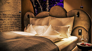 A cosy bed in a Spa Deluxe Double Room at the Hotel Winzer