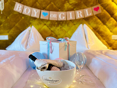 A gender reveal display on a bed at the Hotel Winzer
