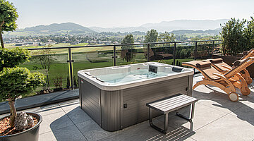 Terrace with a private hot tub at the Private Spa Villa in the Hotel Winzer