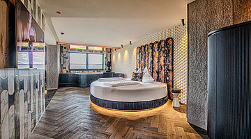 Wolke 7 with Round Bed and Whirlpool Bath Wolke 7 at Hotel Winzer with a round double bed, private whirlpool bath and a spacious living and sleeping area for two