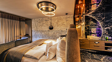 A cosy bed in a Spa Deluxe double room at the Hotel Winzer