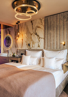A cosy bed in the stylish Spa double room at Hotel Winzer