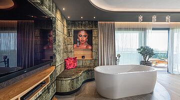 Bedroom with a freestanding bath in the Private Spa Villa at the Hotel Winzer