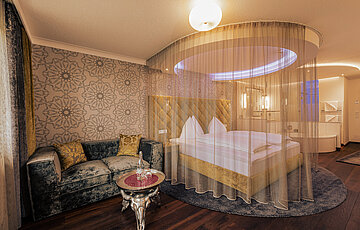 Emotion Double Room with a cosy bed at the Romantik-Wellnesshotel Winzer