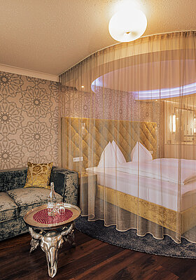 Emotion Double Room with a cosy bed at the Romantik-Wellnesshotel Winzer