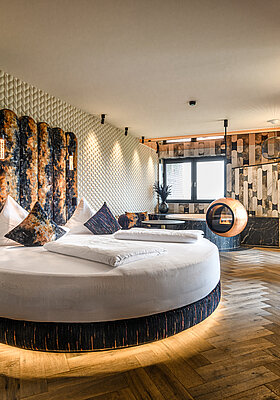 Private Cinema Suite with Round Bed and Design Fireplace Private Cinema Suite at Hotel Winzer with a round double bed, distinctive design fireplace and stylish living area for two