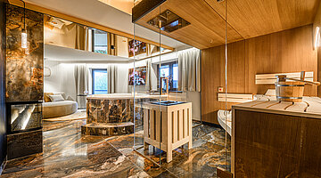 Private Spa with Sauna and Whirlpool Private spa in the Secret Love Suite at Hotel Winzer with an integrated sauna, whirlpool bath, natural stone flooring and an open in-room wellness area
