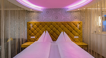Emotion Double Room with a cosy bed at the Romantik-Wellnesshotel Winzer