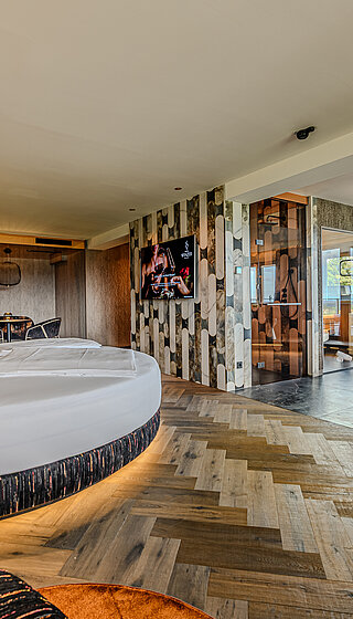 Wolke 7 with Private Spa Spacious Wolke 7 at Hotel Winzer with a round double bed, private spa, design fireplace and generous space for two