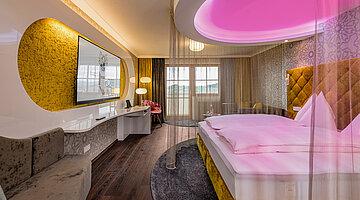 Emotion Double Room with a cosy bed at the Romantik-Wellnesshotel Winzer